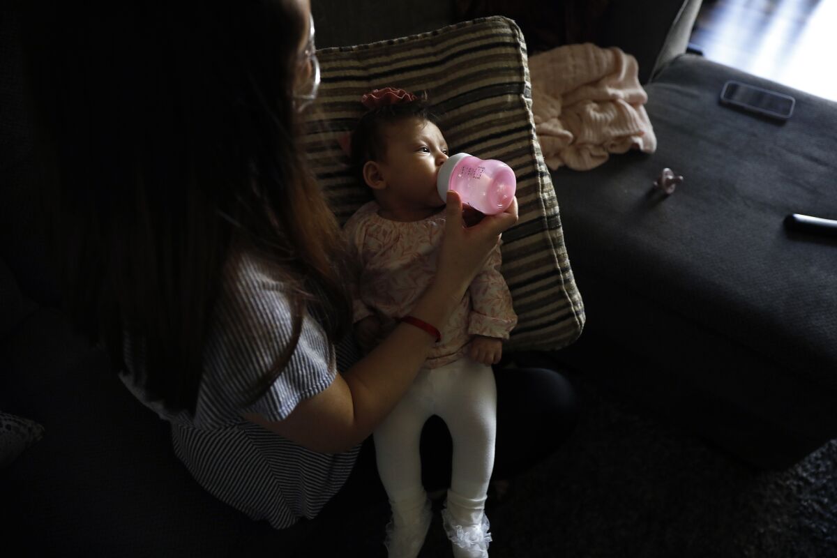 Veronica Gutierrez, 26, feeds her 3-month-old daughter, Alessandra, at home in Wilmington.