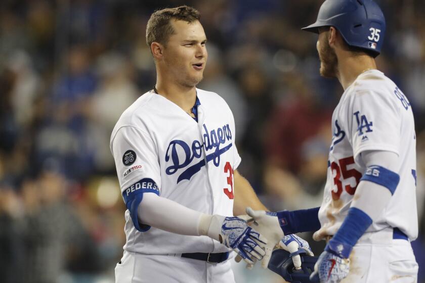 LOS ANGELES, CALIF. - MAY 31, 2019. Dodgers outfielder Joc Pederson is congratulated by teammate Cody Bellinger after hitting a solo home run against the Phillies in the fifth inning on Friday night, May 31, 2019. (Luis Sinco/Los Angeles Times)