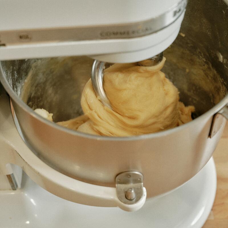 A mixer with dough swirled on its dough hook