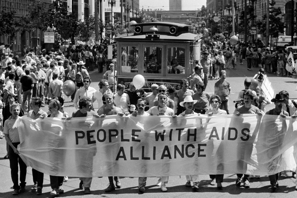 AIDS patients carry a banner up Market Street during the 1983 Gay Freedom Day Parade in San Francisco. (Eric Risberg / Associated Press)