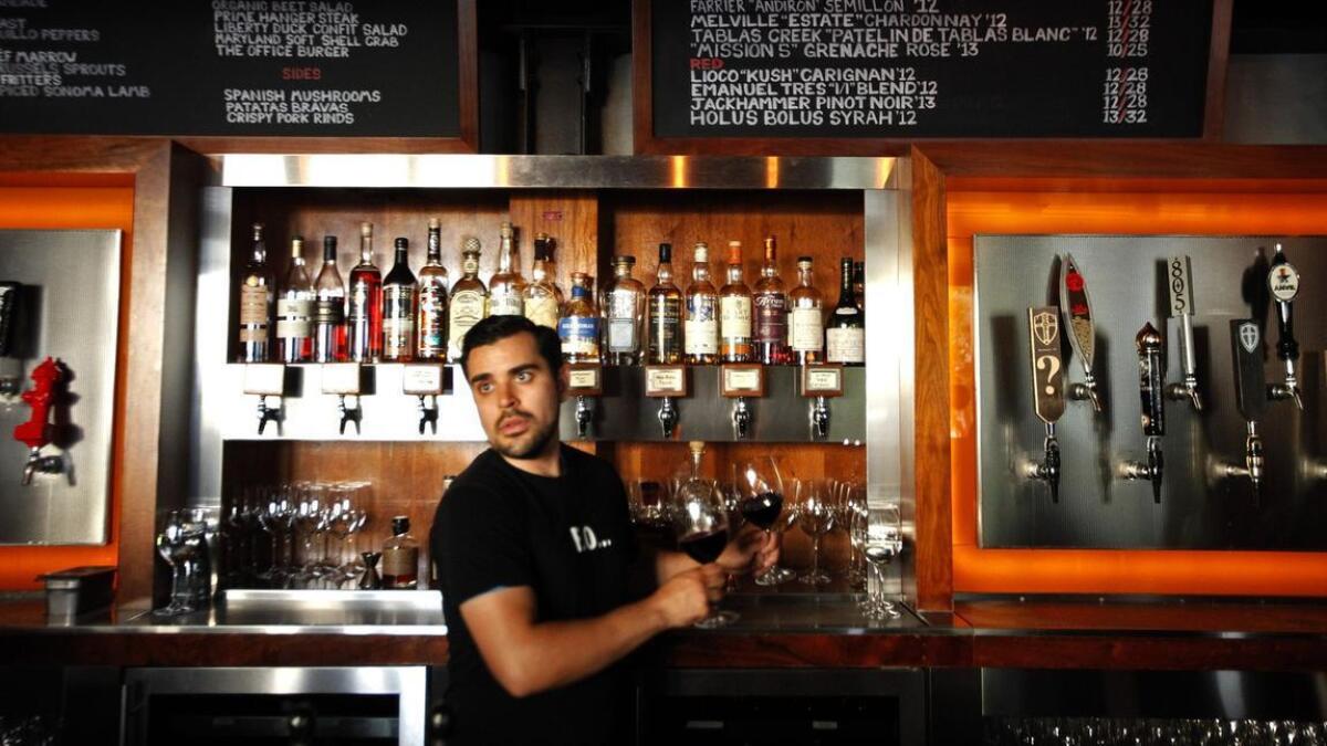 Bartender Eric Solis at Father's Office in Culver City pulls a few glasses of wine on tap. The restaurant was the first to offer wine on tap in L.A.