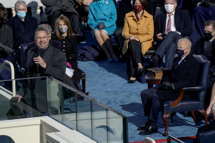Washington , DC - January 20: U.S. President Joe Biden listens as singer Garth Brooks sings "Amazing Grace" after taking the oath of office to become the 46th President of the United States during the 59th presidential inauguration in Washington, D.C. on Wednesday, Jan. 20, 2021. (Kent Nishimura / Los Angeles Times)
