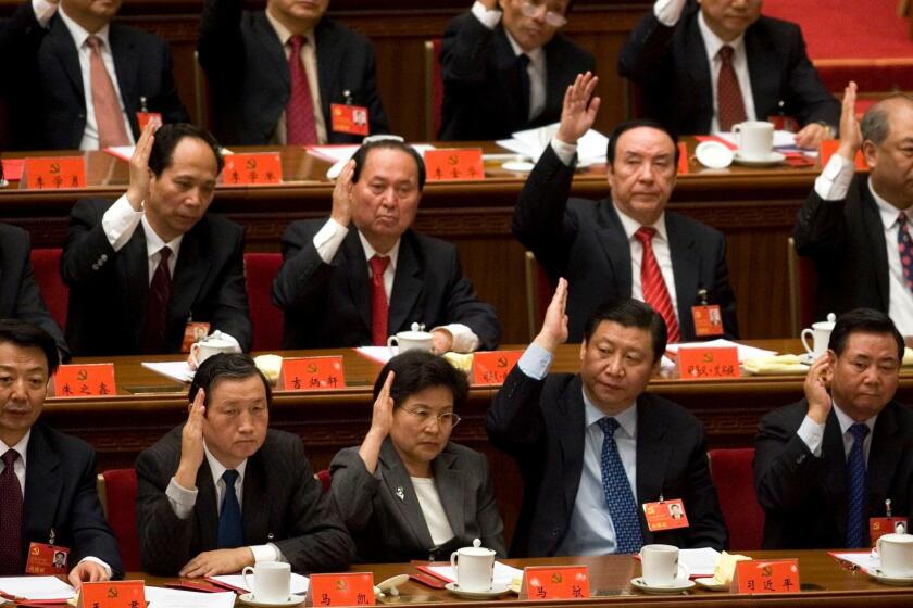 China's top leadership including rising stars like Shanghai party chief Xi Jinping, bottom second from right and Liaoning party chief Li Keqiang top right raise their hands to approve resolutions passed during the closing ceremony for the 17 Communist Party Congress held at the Great Hall of the People in Beijing, China, Sunday, Oct. 21, 2007. More than 2,200 delegates to a weeklong Communist Party congress were expected Sunday to select a Central Committee _ the body that appoints China's top leaders and sets broad policy goals. (AP Photo/Ng Han Guan) ORG XMIT: XHG104