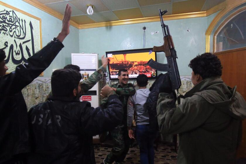 Members of the Hashed al-Shaabi (Popular Mobilisation units) watch the televised statement of Iraqi Prime Minister Haider al-Abadi in the southern city of Basra on December9, 2017. Abadi declared victory in a three-year war by Iraqi forces to expel the Islamic State jihadist group that at its height endangered Iraq's very existence. / AFP PHOTO / HAIDAR MOHAMMED ALIHAIDAR MOHAMMED ALI/AFP/Getty Images ** OUTS - ELSENT, FPG, CM - OUTS * NM, PH, VA if sourced by CT, LA or MoD **