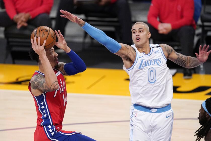 Philadelphia 76ers forward Danny Green, left, shoots as Los Angeles Lakers forward Kyle Kuzma defends during the first half of an NBA basketball game Thursday, March 25, 2021, in Los Angeles. (AP Photo/Mark J. Terrill)