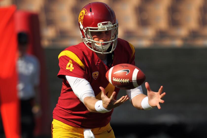 USC backup quarterback Max Browne bobbles a snap during the 2014 spring game.