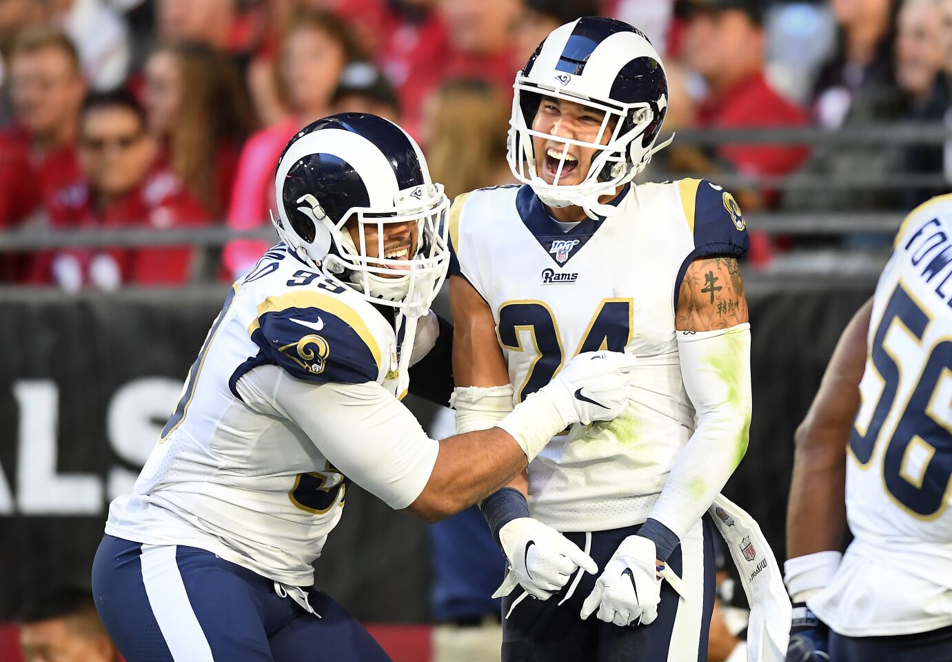 Rams safety Taylor Rapp, left, is congratulated by defensive lineman Aaron Donald after he returned an interception for a touchdown.