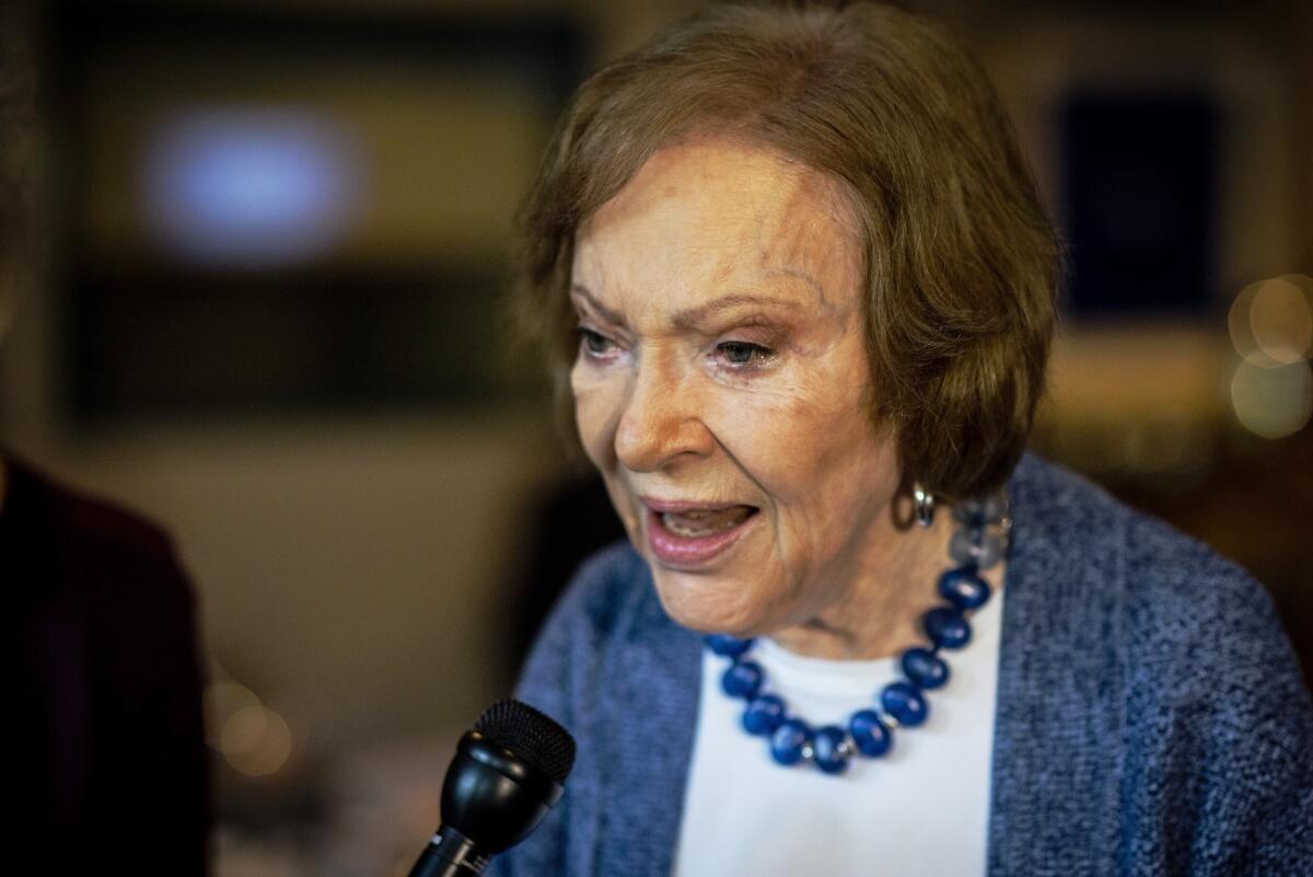 Former First Lady Rosalynn Carter speaks into a microphone.