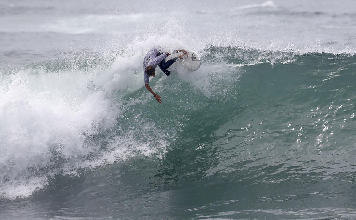 Hudson Saunders of Laguna Beach banks backside off the wall of a big wave.