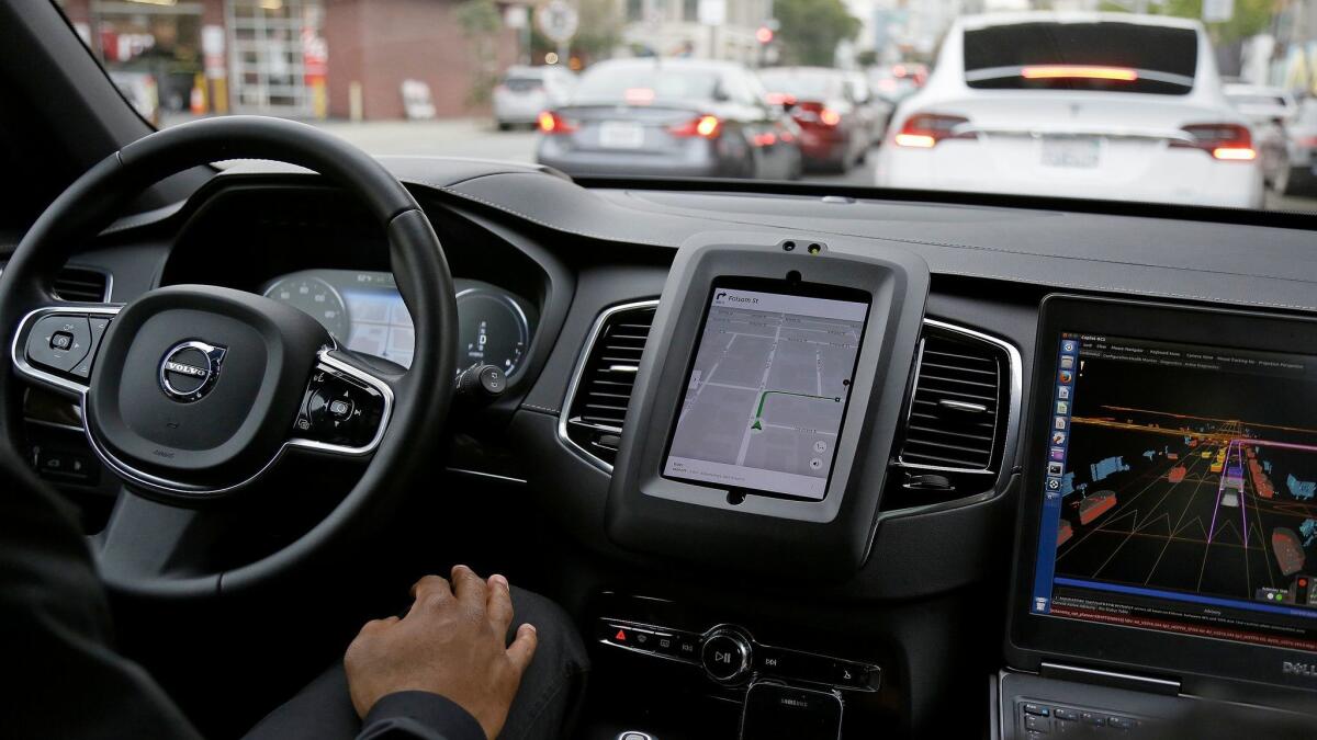 An Uber car in self-driving mode waits in traffic during a test drive in San Francisco on Dec. 13, 2016.