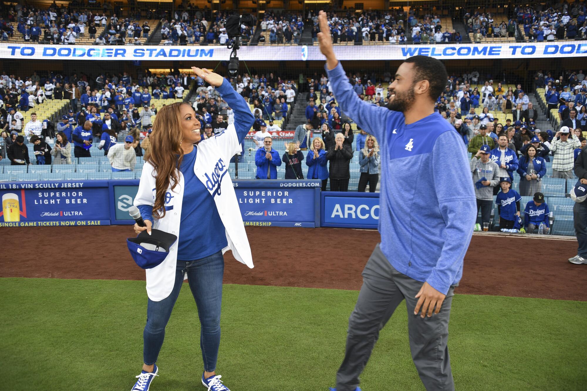 Holly Robinson-Peete gives her son, RJ Peete, a high-five before a game at Dodger Stadium.