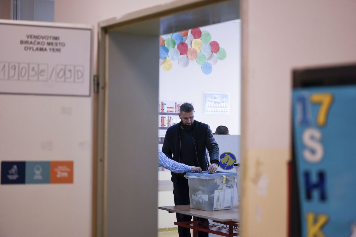 A man casts his ballot at a polling station in Pristina, Kosovo, Sunday, Oct. 17, 2021. Kosovo is holding municipal elections Sunday in which the eight-month-old leftwing governing party aims at capturing the capital Pristina's city hall. (AP Photo/Visar Kryeziu)