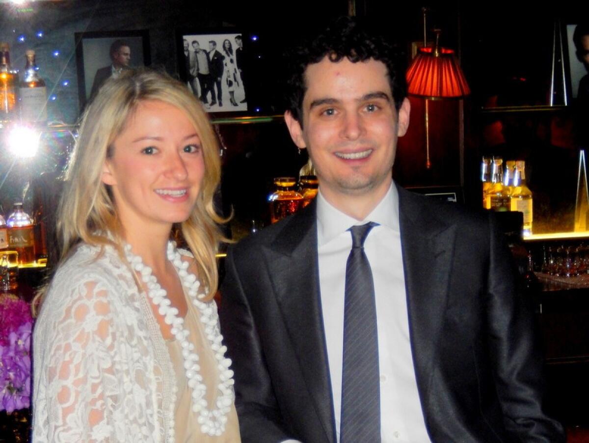 Olivia Hamilton, left, and Damien Chazelle, writer-director of "Whiplash," attend the Hollywood Reporter's Oscar nominees party.