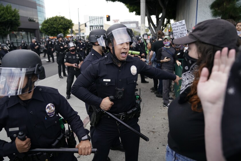A Los Angeles police officer yells at a protester last month in the Fairfax district.