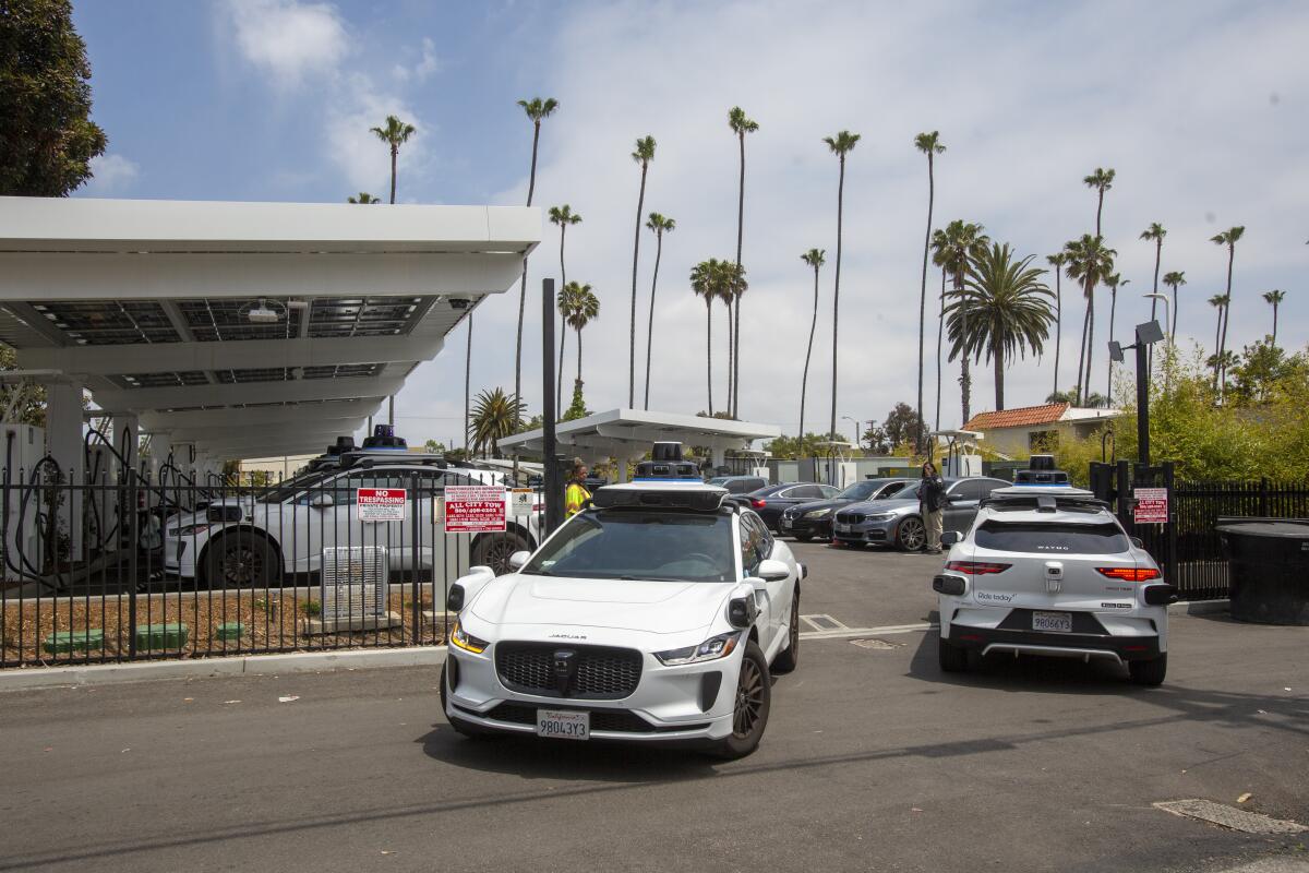 White cars enter and exit a parking lot.