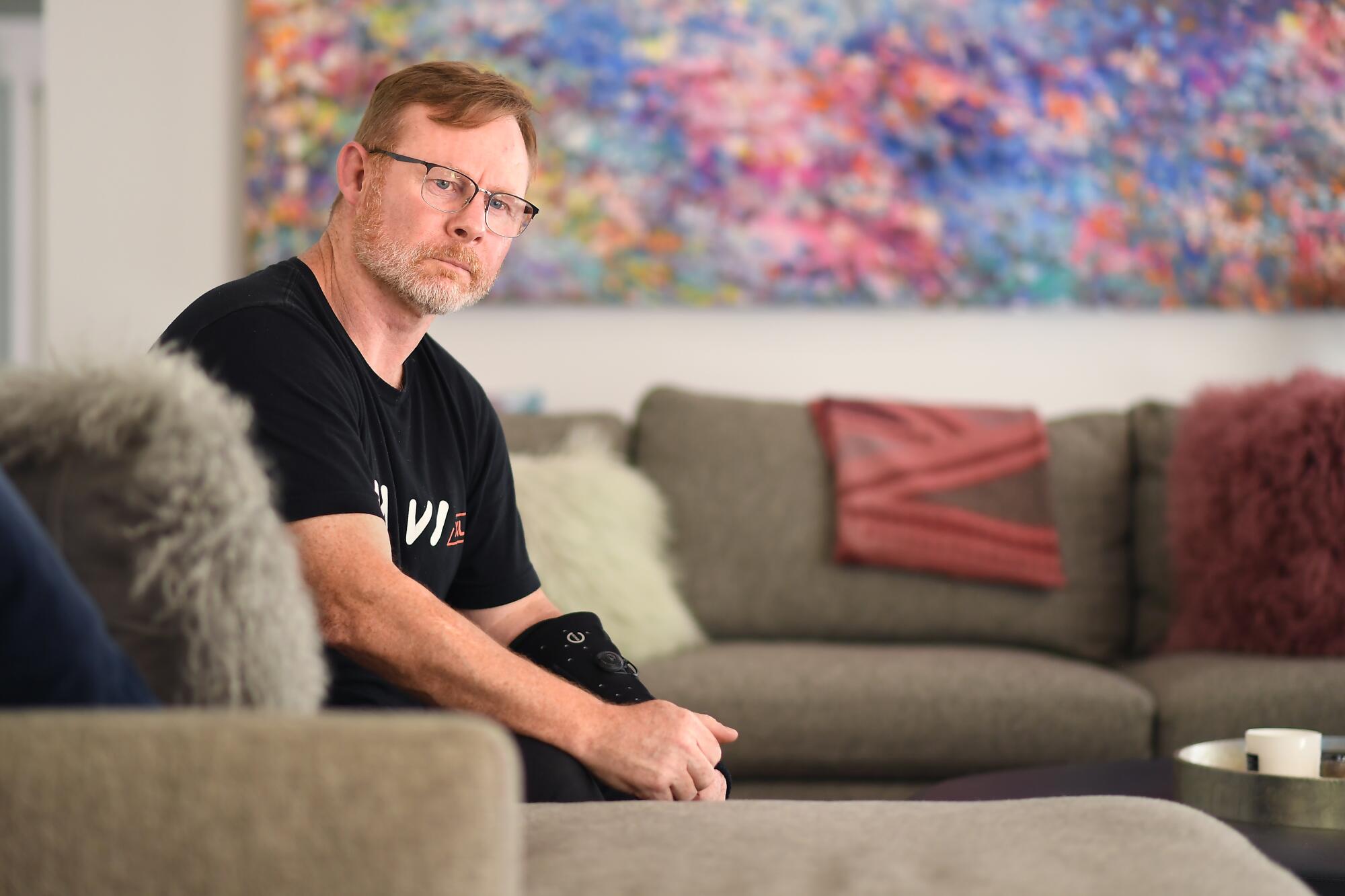 Former Hollywood trainer, boxer and fight sequencer Nigel Hudson poses on a couch.