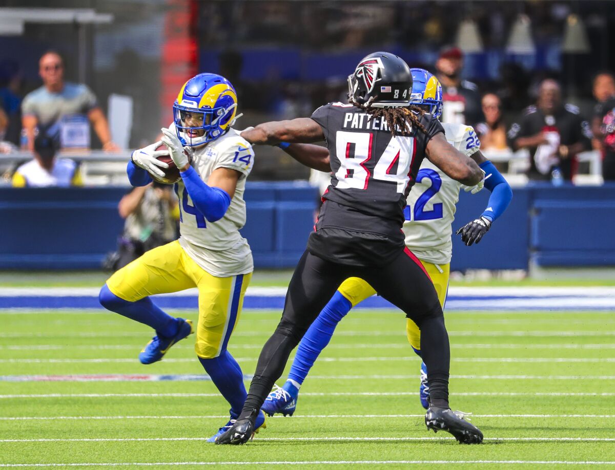 The Rams' Cobie Durant runs after intercepting a pass that was deflected by the hands of the Falcons' Cordarrelle Patterson.