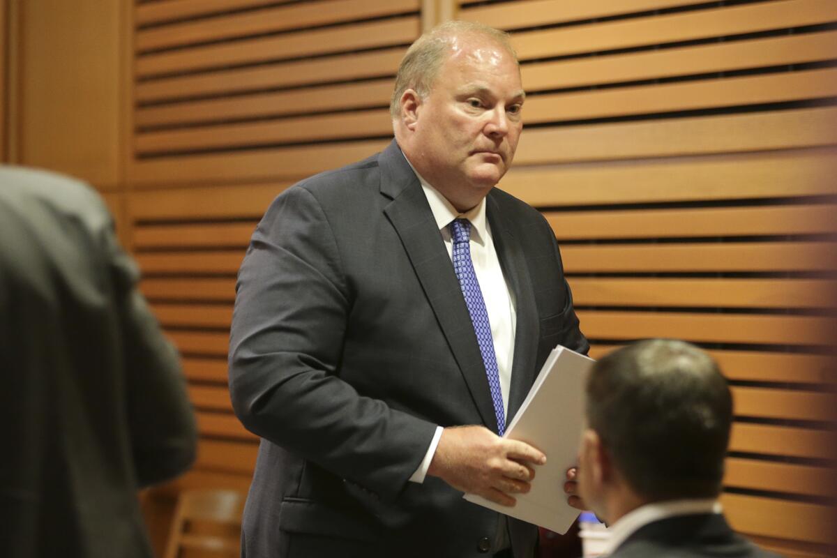 Former Wisconsin Supreme Court Justice Michael Gableman leaves the stand after testifying.