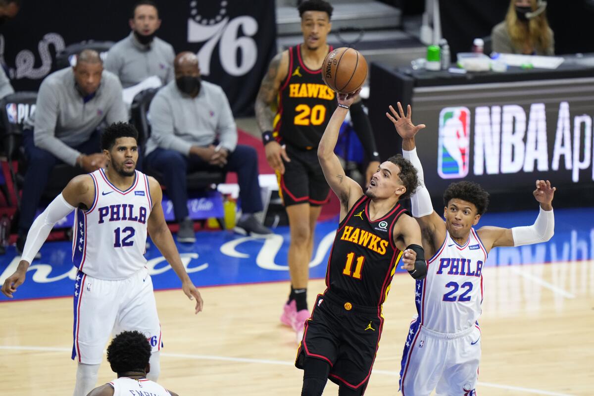 Atlanta's Trae Young  shoots in front of  Philadelphia's Matisse Thybulle during the second half.