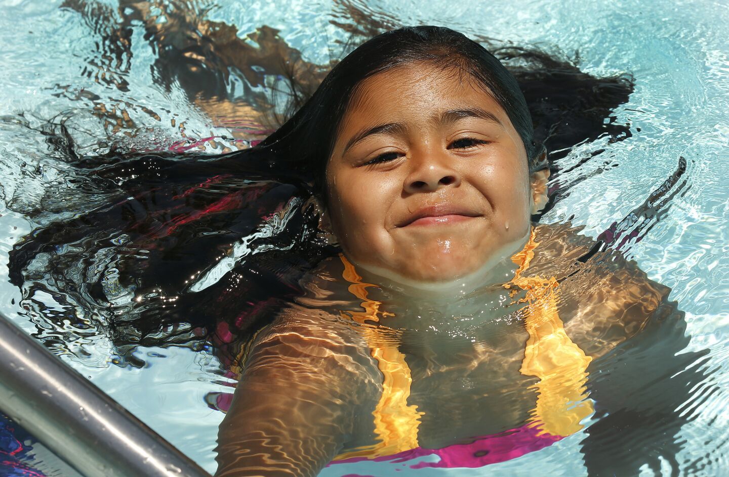Melissa Garcia, 6, cools off in the Reseda Park pool in the San Fernando Valley on Friday afternoon.