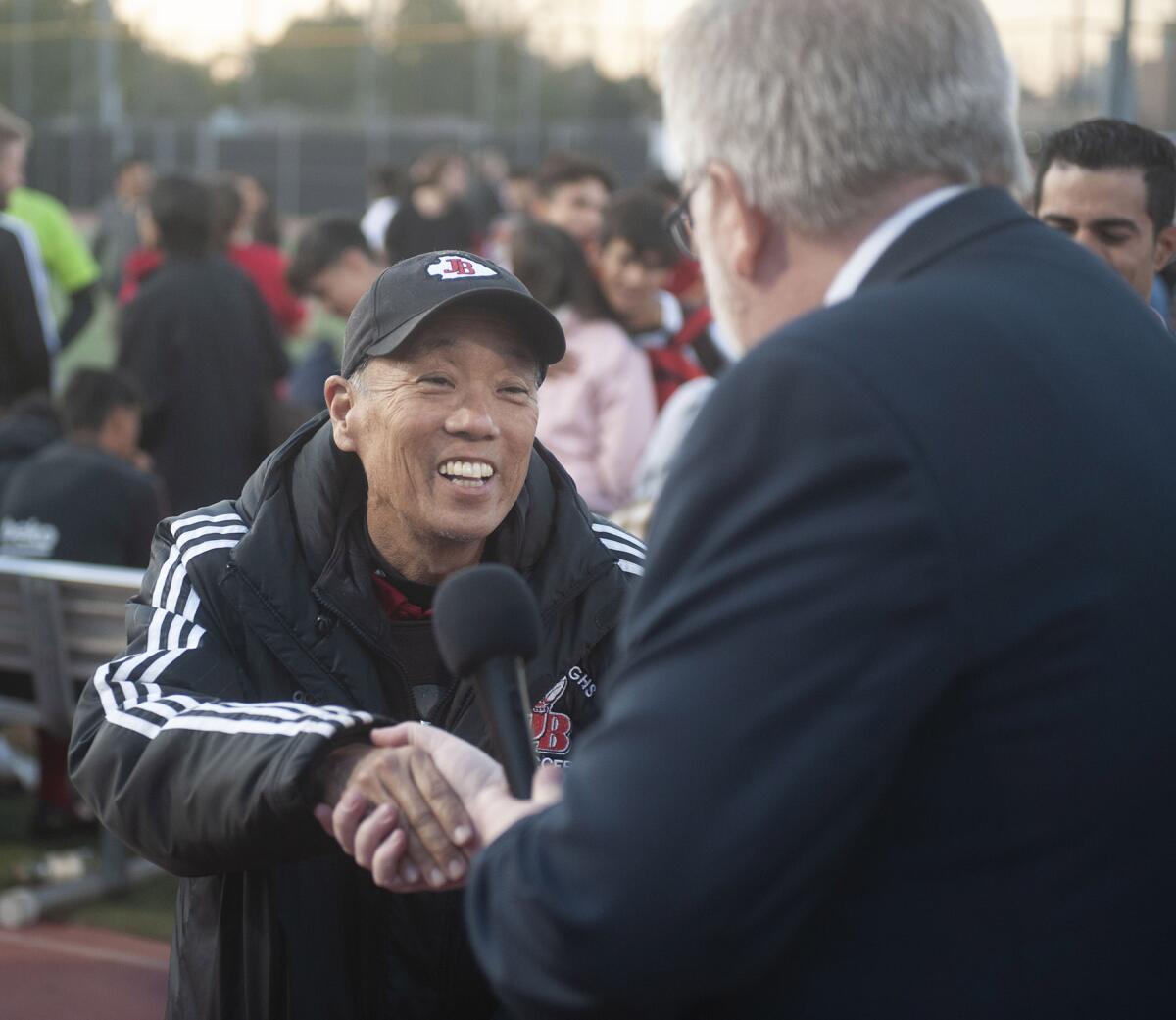 Former Burroughs High boys soccer coach Mike Kodama, left, is recognized by Burbank Unified School Board Vice President Steve Frintner during a tribute to Kodama Thursday. (Photo by Miguel Vasconcellos)