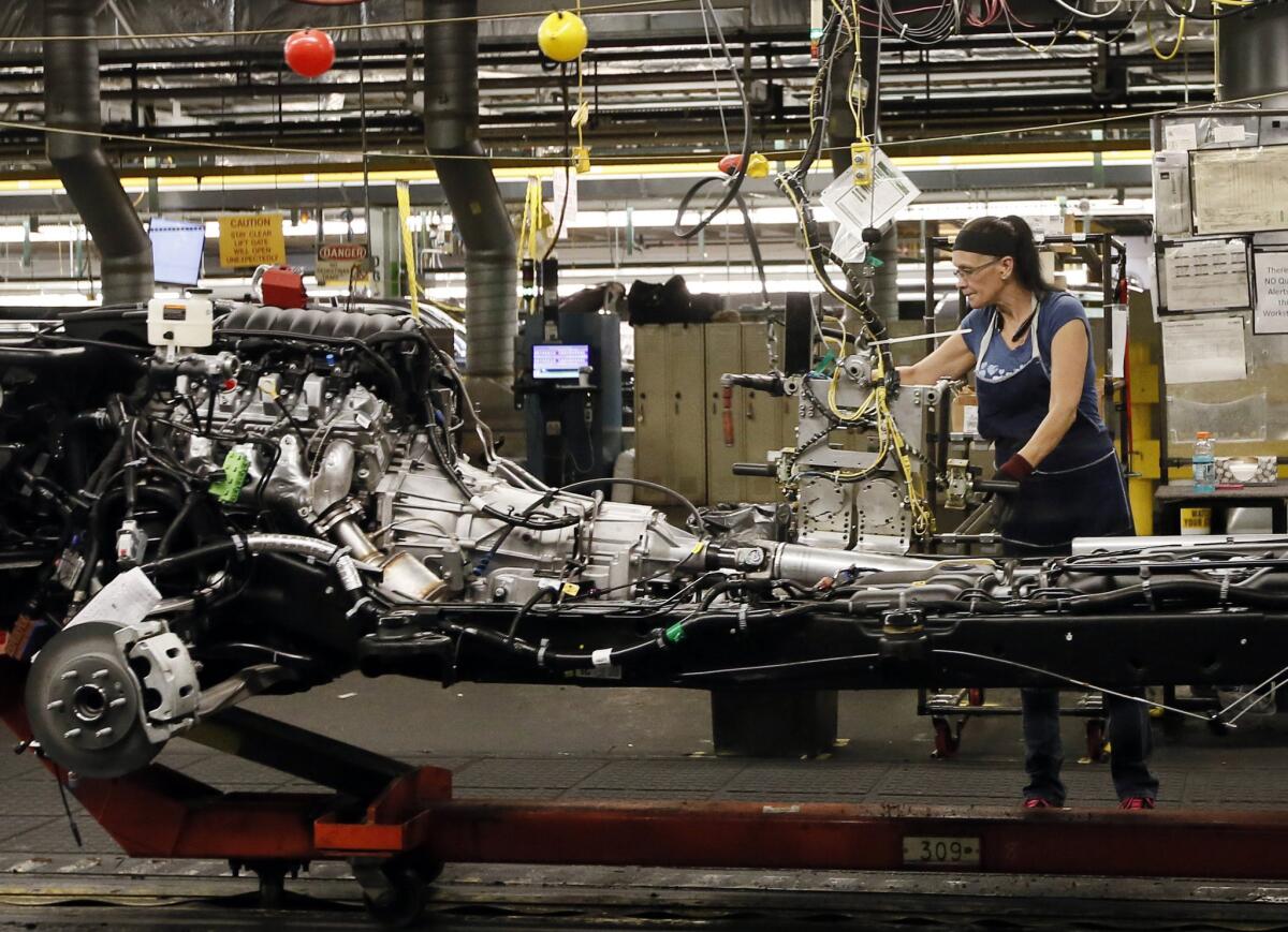 An employee works on the assembly line at the General Motors plant in Arlington, Texas, on July 14.