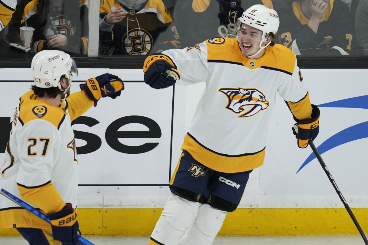 Nashville Predators center Cody Glass, right, is congratulated by Ryan McDonagh (27) after his goal against Boston Bruins goaltender Linus Ullmark during the second period of an NHL hockey game Tuesday, March 28, 2023, in Boston. (AP Photo/Charles Krupa)