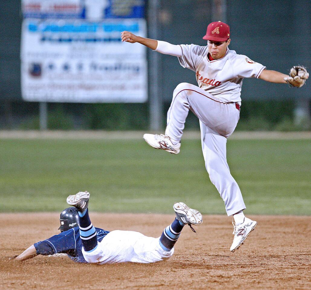 CV's Nick Diaz dives safely to second as Arcadia's Nick Ibarra jumps for the throw during a game on Friday, May 16, 2014.