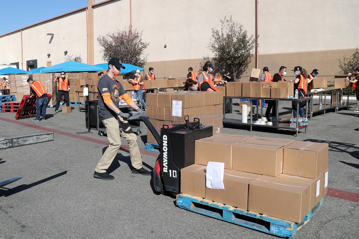 An employee rolls out boxes of frozen food at Second Harvest's distribution facility.