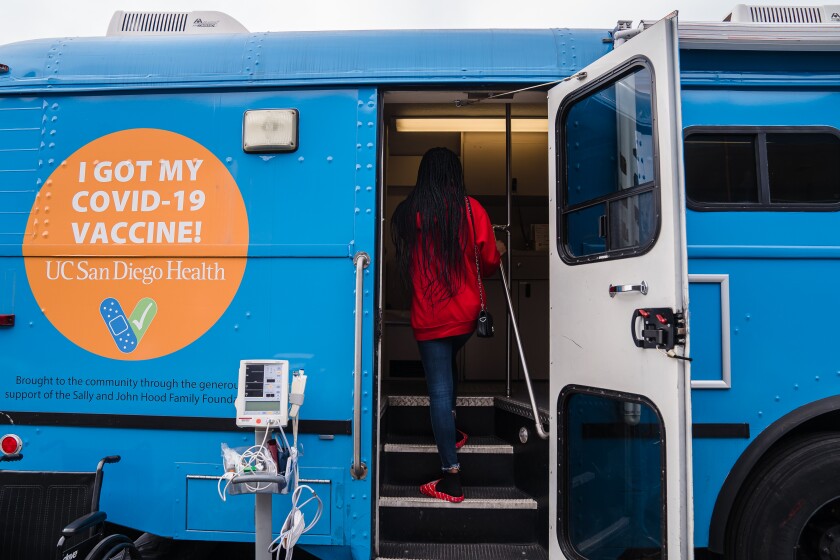 Blossom Bess, 15, walks on to an UC San Diego Health Mobile Clinic to receive her first shot of the vaccine for Covid-19.