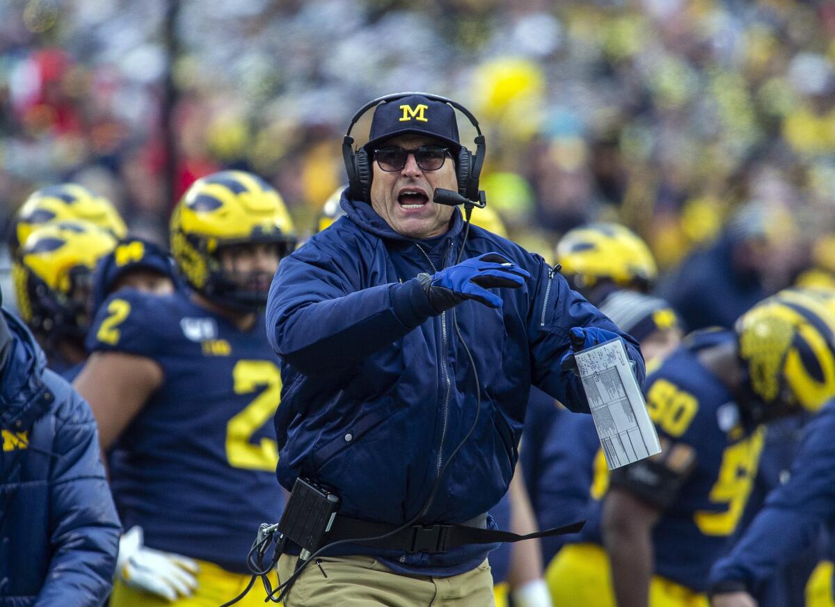 Michigan coach Jim Harbaugh calls a timeout 