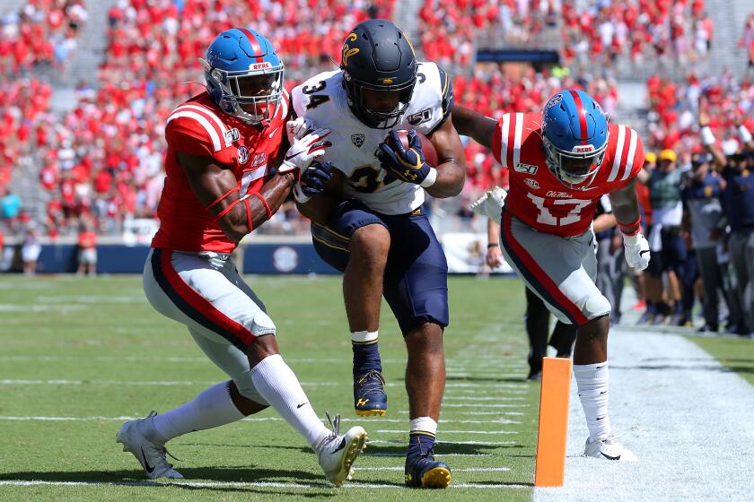 OXFORD, MISSISSIPPI - SEPTEMBER 21: Christopher Brown Jr. #34 of the California Golden Bears rushes for a touchdown as Willie Hibbler #17 of the Mississippi Rebels and Jon Haynes #5 defend during the first half of a game at Vaught-Hemingway Stadium on September 21, 2019 in Oxford, Mississippi. (Photo by Jonathan Bachman/Getty Images) ** OUTS - ELSENT, FPG, CM - OUTS * NM, PH, VA if sourced by CT, LA or MoD **