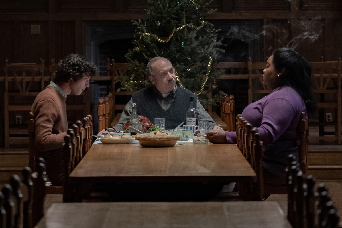 Three people have a meal at a table.
