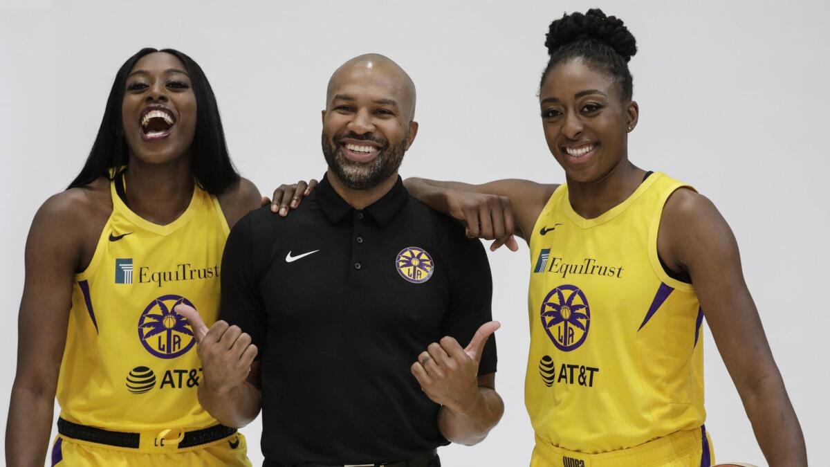 Sparks teammates and sisters Chiney Ogwumike, left, and Nneka Ogwumike pose with Sparks coach Derek Fisher on media day. The addition of Chiney Ogwumike should enhance the Sparks' rebounding efforts this season.