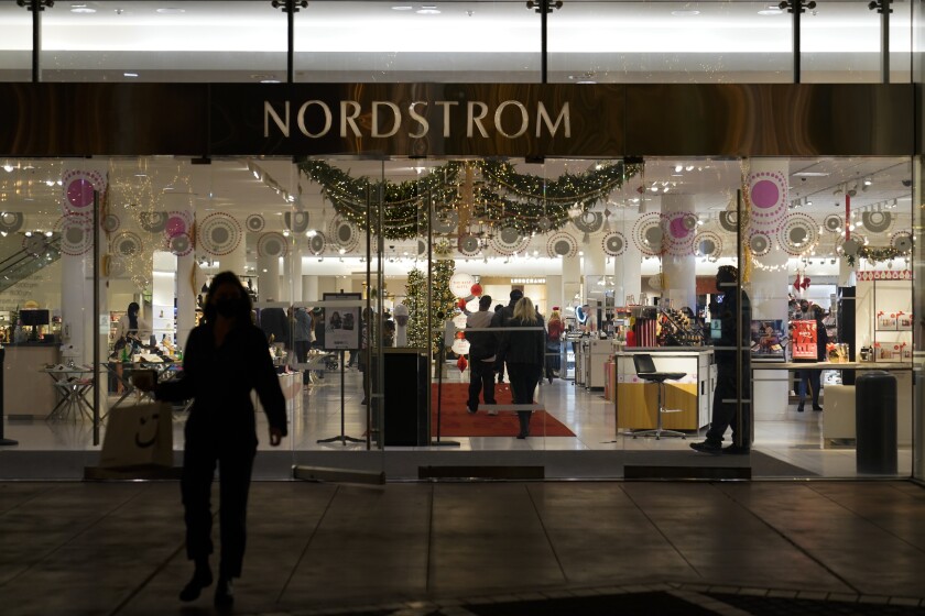 A security guard at the entrance to a Nordstrom department store at the Grove mall in Los Angeles