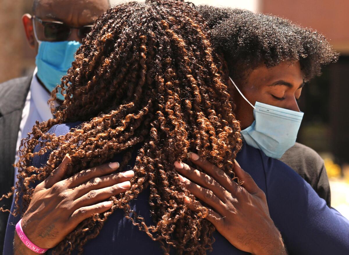 Compton resident Dalvin Price receives a hug of support from Compton City Mayor Aja Brown