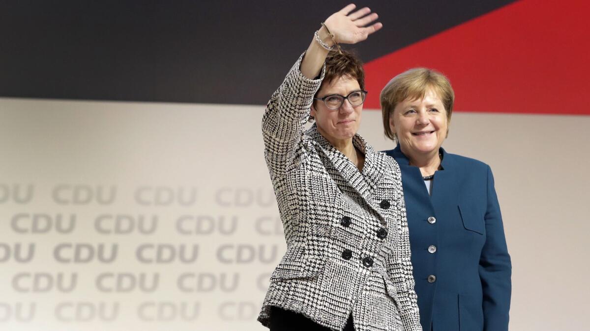 Newly elected Christian Democratic leader Annegret Kramp-Karrenbauer, left, with German Chancellor Angela Merkel, a fellow centrist whom she is on track to succeed.