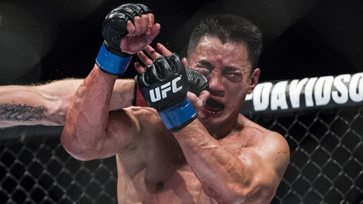 Cung Le is punched during his UFC middleweight loss to Michael Bisping in Macao on Aug. 23.