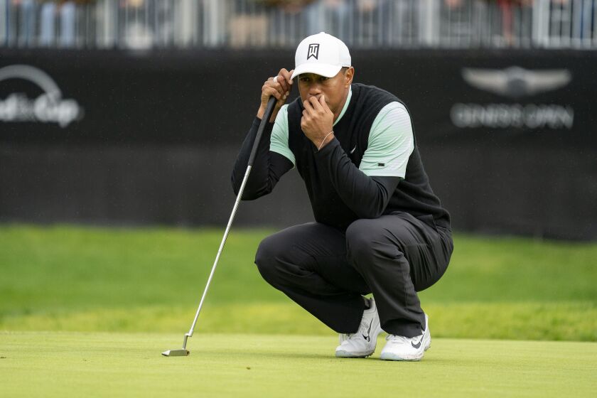 Tiger Woods lines up his putt on the 14th green during the second day of the Genesis Open at Riviera Country Club on Friday.