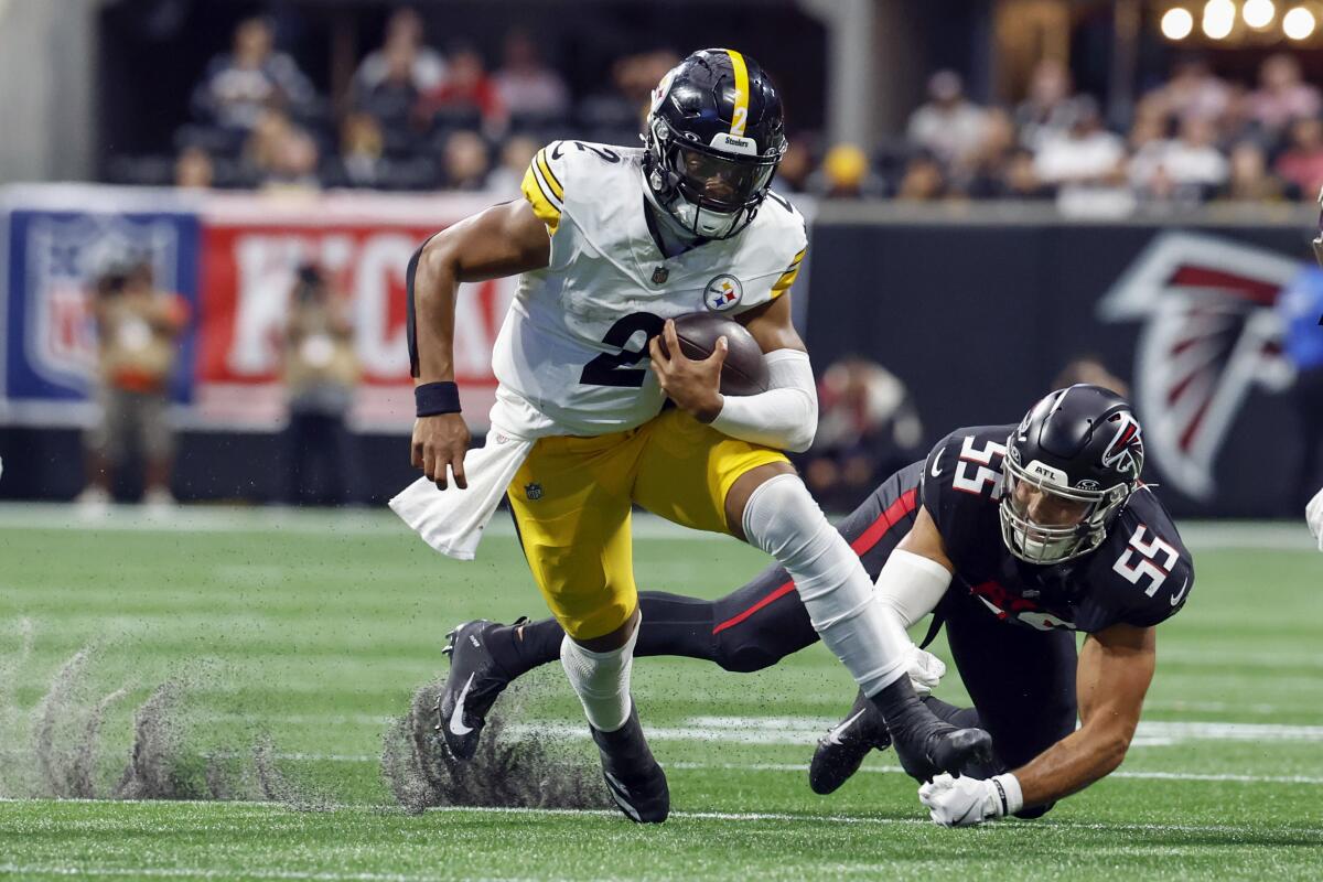  Steelers quarterback Justin Fields (2) carries the ball as  Falcons linebacker Kaden Elliss (55) pursues.