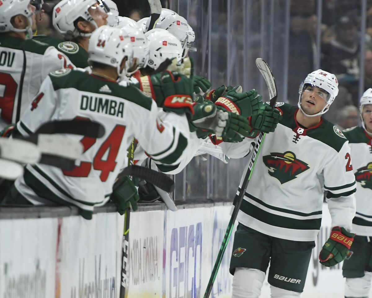 Minnesota Wild left wing Kevin Fiala (22) is congratulated by the bench after scoring a goal against the Anaheim Ducks during the second period of an NHL hockey game Friday, Oct. 15, 2021, in Anaheim, Calif. (AP Photo/John McCoy)