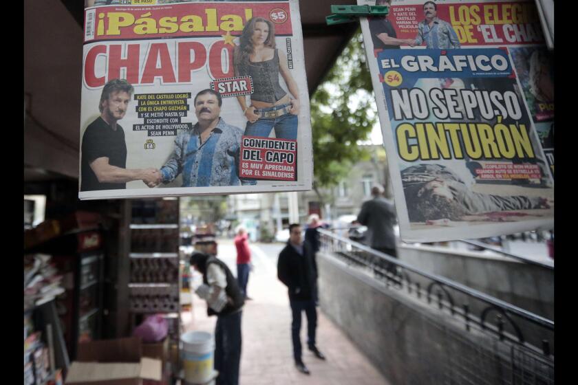 A newspaper shows a picture of drug lord Joaquin Guzman, aka "El Chapo," shaking hands with actor Sean Penn, left, as seen at a newsstand in Mexico City on Sunday.