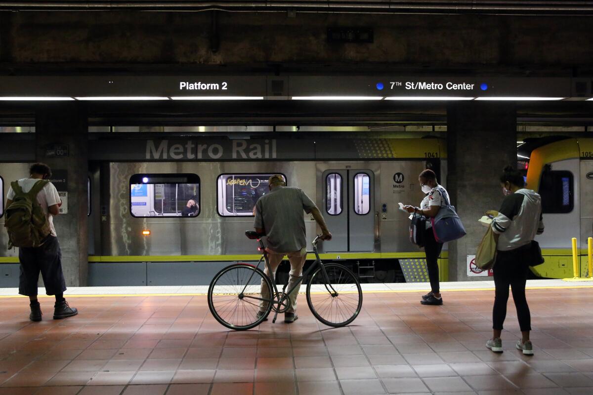 Passengers wait for the A Line on the platform of the 7th Street station.