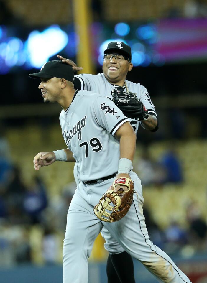White Sox reliever Ronald Belisario and first baseman Jose Abreu celebrate after the 4-1 win.