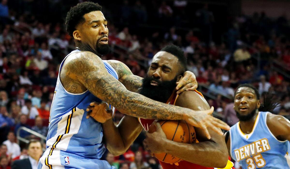 Nuggets forward Wilson Chandler finds one way to slow down Rockets guard James Harden, who had 50 points on Thursday night.