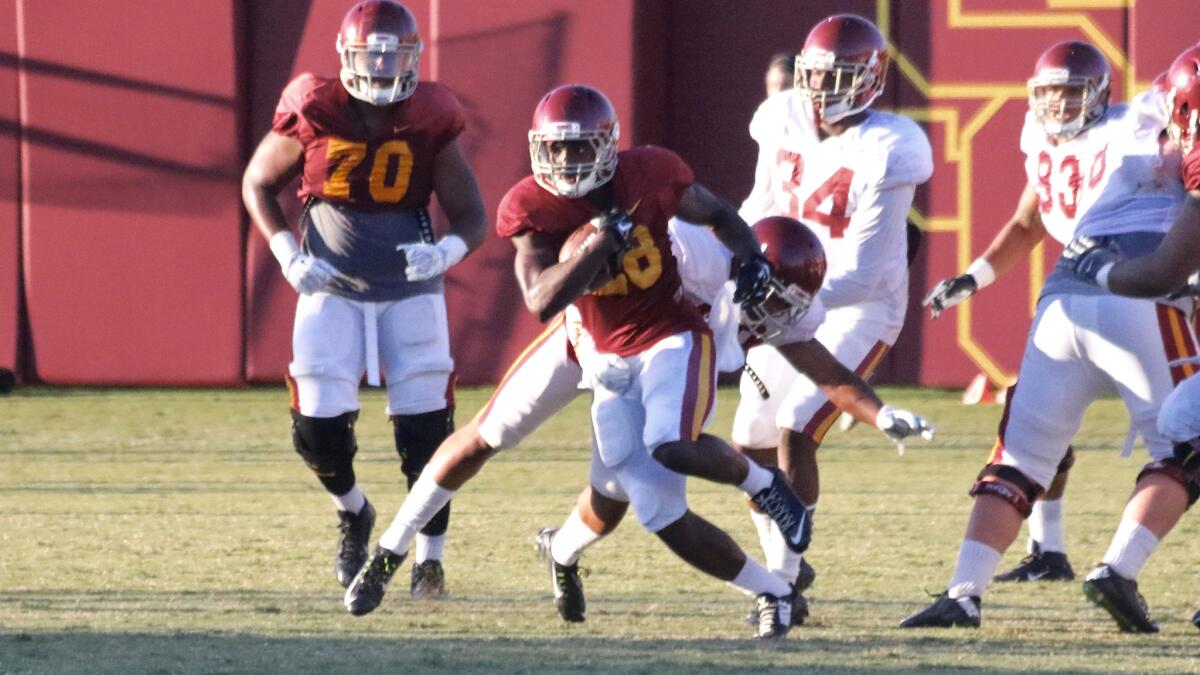 USC freshman running back Aca'Cedric Ware makes a defender miss during a fall camp practice at Howard Jones Field.