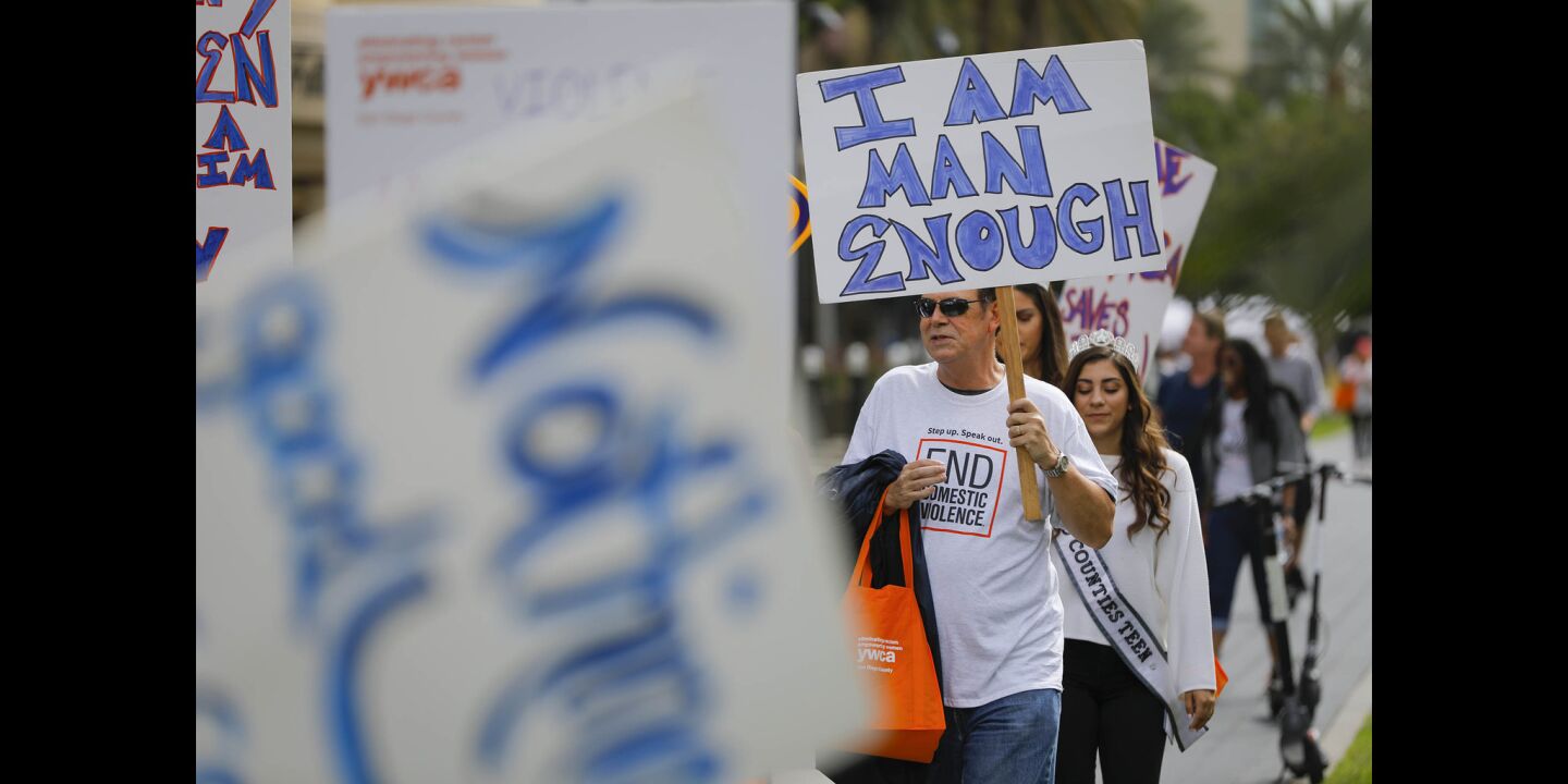 A couple of hundred walked through the Gaslamp Quarter during the YWCA'S 11th annual "Walk a Mile in Her Shoes," taking a stand against domestic violence.