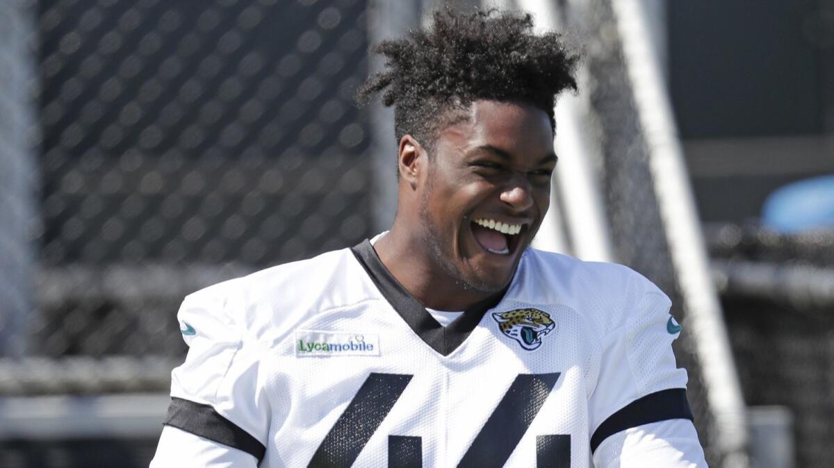 Jaguars linebacker Myles Jack laughs with teammates before practice, May 21 in Jacksonville, Fla.