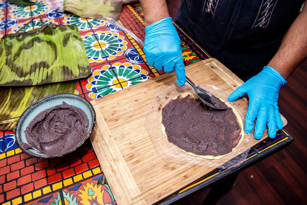Alfonso "Poncho" Martinez of Poncho's Tlayudas demonstrates making a black bean tamale.