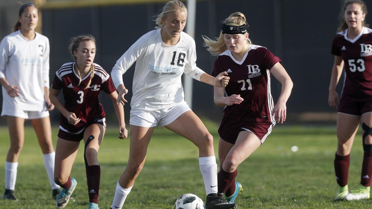 Corona del Mar High's Ava McKenzie (18) and Laguna Beach's Jayd Sprague (71), shown here on Jan. 5, 2018, will open the CIF Southern Section girls' soccer playoffs with their respective teams on Thursday.